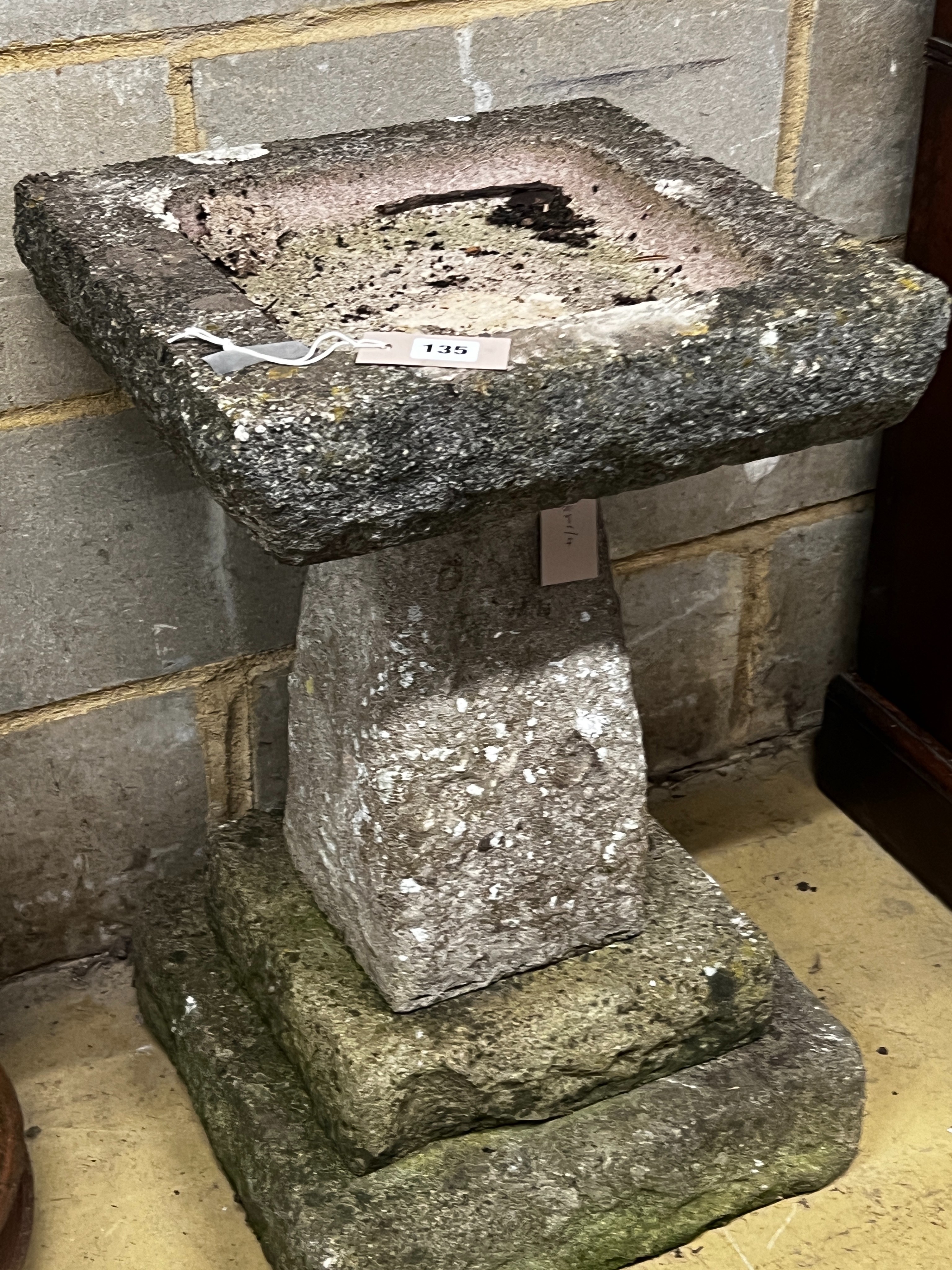 A reconstituted stone garden bird bath, width 40cm, height 65cm